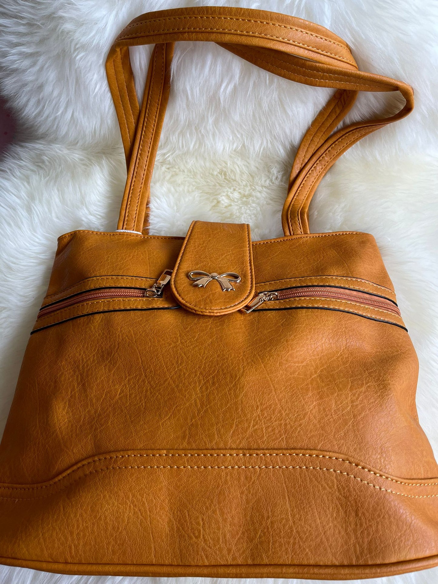 Tan Handbag with bow detail and double zips across the front.